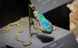 A necklace with a blue and green opal in it.